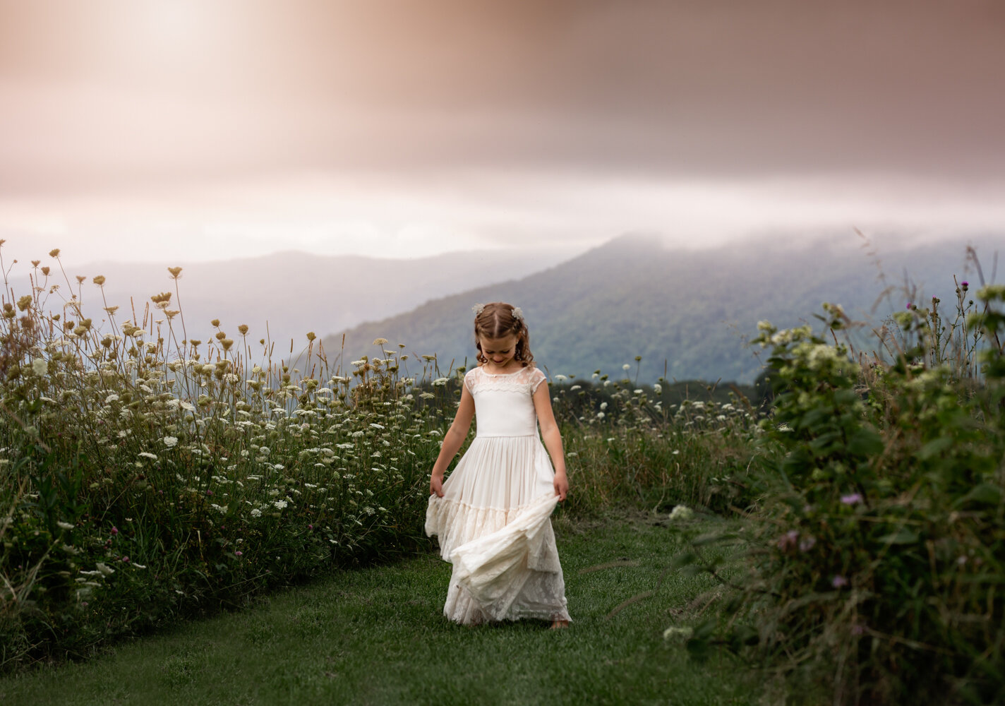 girl in white dress with wildflowers Asheville Family Photographer