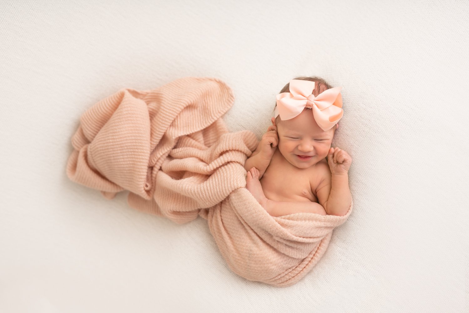 newborn baby girl with a pink bow - Asheville NC Newborn Photographer