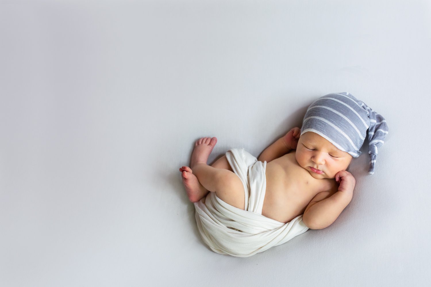 Baby boy with sleeping cap on best newborn photographer in Asheville, NC