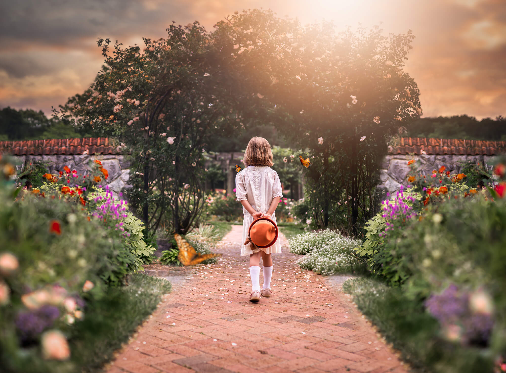 A little girl exploring a garden with butterflies