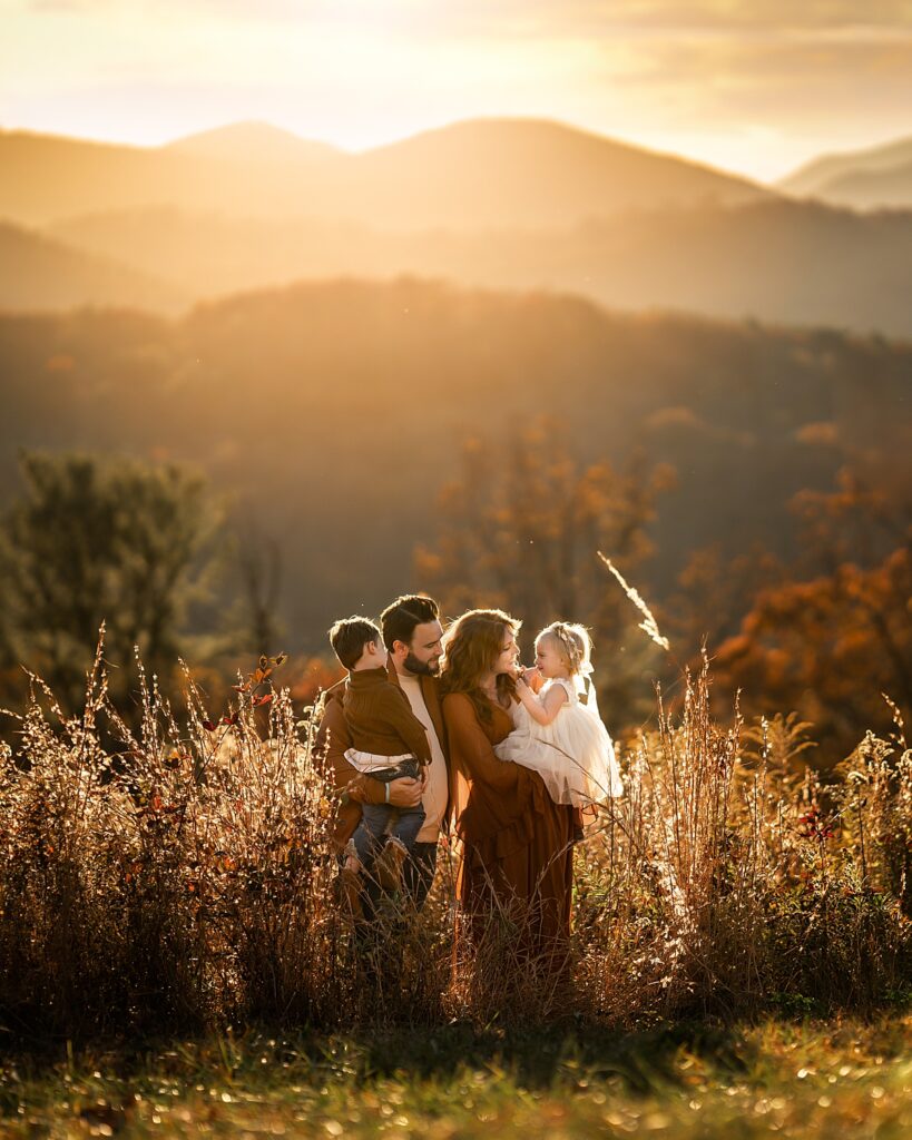 A family stands in front of the mountains during their fall family photos in ASheville NC
